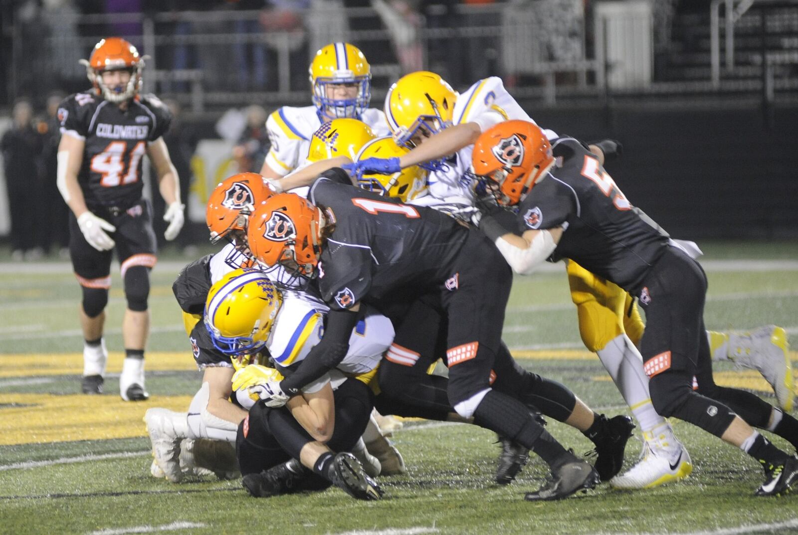 Coldwater defenders Ross Weigel (1) and Alex May (5) take down Matt Rethman. Marion Local defeated Coldwater 40-19 in a D-VI, Region 24 final at Sidney on Friday, Nov. 16, 2018. MARC PENDLETON / STAFF