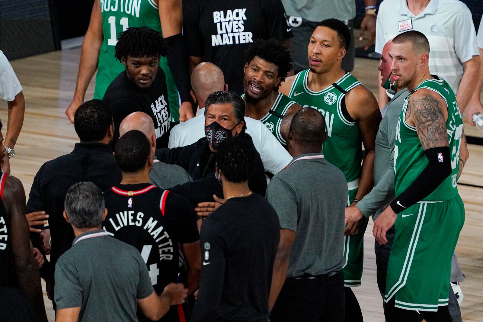 Boston Celtics guard Marcus Smart (36) exchanges works with members of th eToronto Raptors following an NBA conference semifinal playoff basketball game Wednesday, Sept. 9, 2020, in Lake Buena Vista, Fla. The Raptors defeated the Celtics 125-122. (AP Photo/Mark J. Terrill)