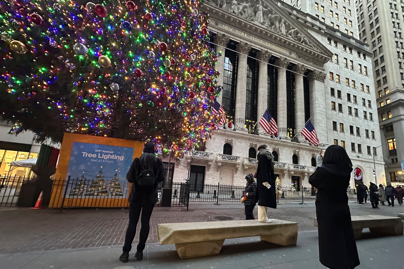 FIL:E - People photograph the New York Stock Exchange in New York's Financial District on Dec. 23, 2024. (AP Photo/Peter Morgan, File)