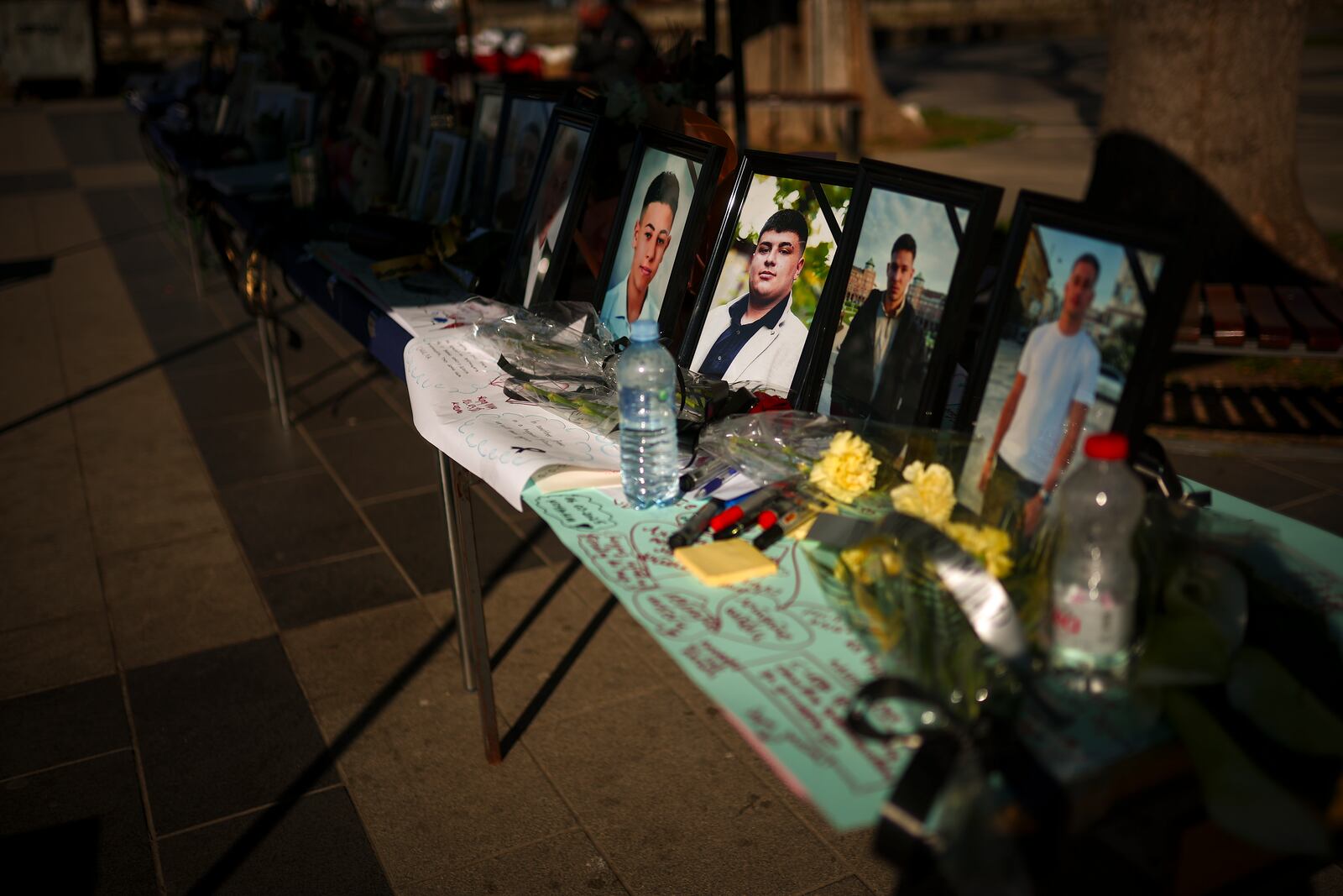 Photographs of the victims of a massive nightclub fire, are placed in a square in the town of Kocani, North Macedonia, Thursday, March 20, 2025. (AP Photo/Armin Durgut)