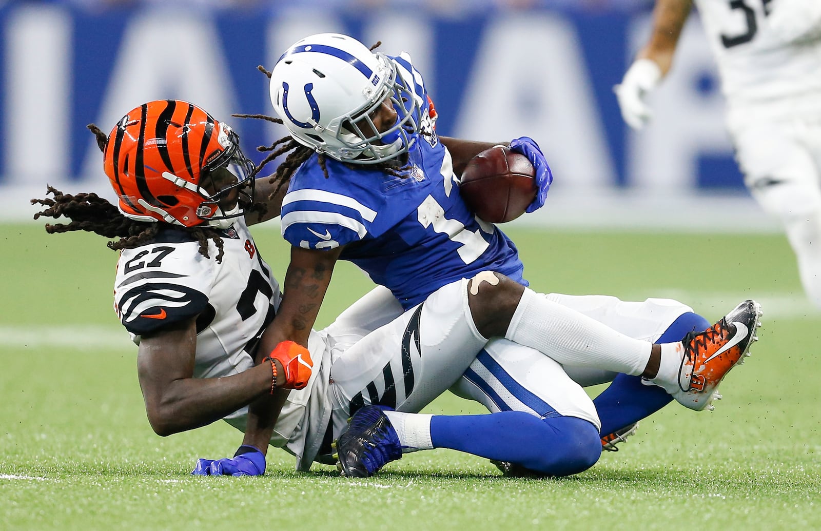 Cincinnati Bengals defensive back Dre Kirkpatrick (27) hauls down Indianapolis Colts wide receiver T.Y. Hilton (13) in the second half on Sunday, Sept. 9, 2018 at Lucas Oil Stadium in Indianapolis, Ind. The Indianapolis Colts lost 34-23 to the Cincinnati Bengals. (Sam Riche/TNS)