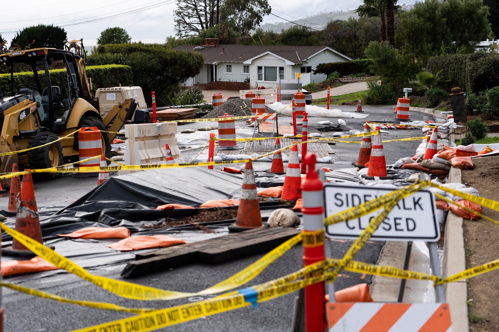 FILE - Caution tape closes off streets due to land movement intensified by recent atmospheric rivers in Rancho Palos Verdes, Calif., Feb. 20, 2024. (AP Photo/Jae C. Hong, File)