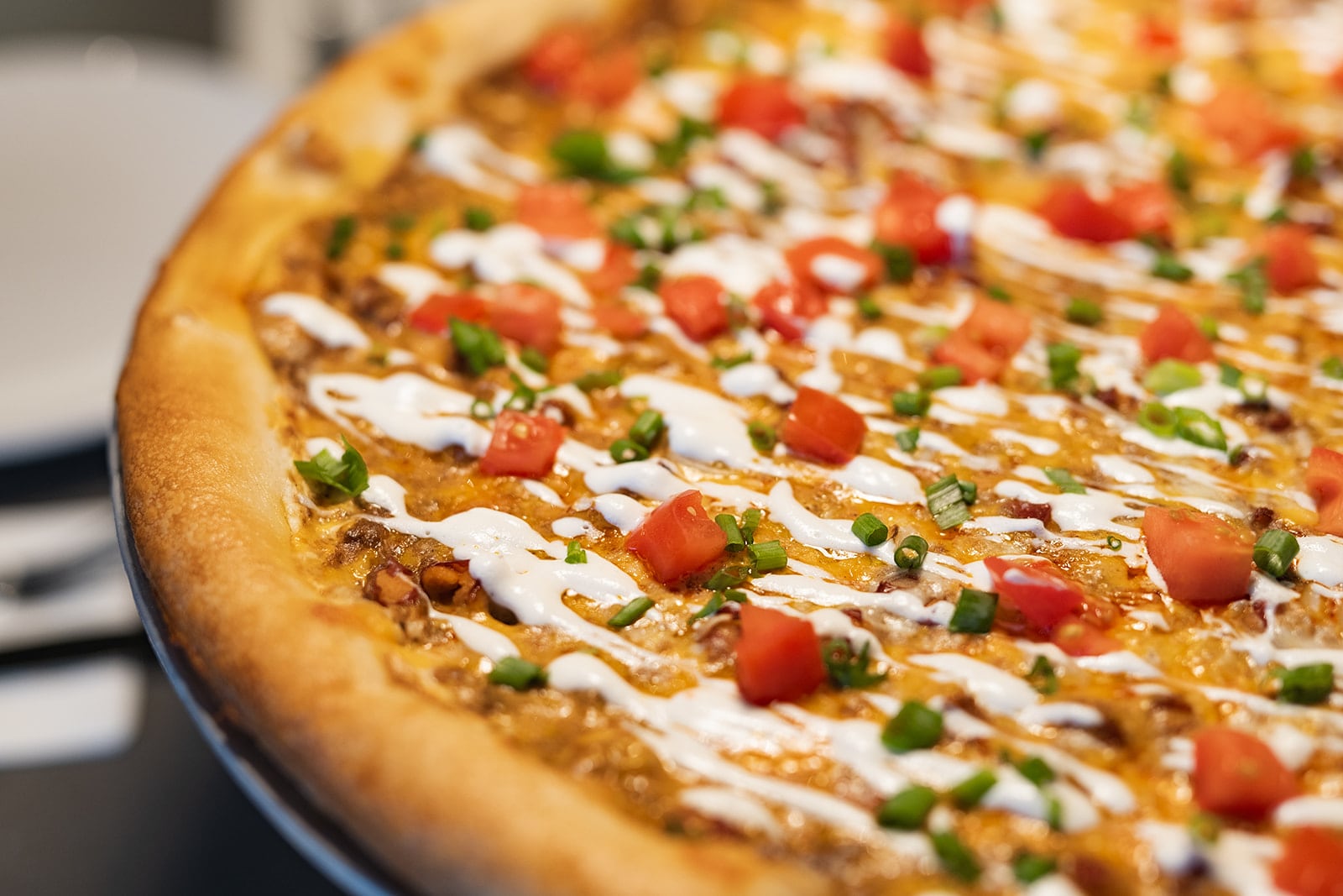 The Skyline Dip Deluxe pizza at Dewey's features a cream cheese base, topped with Skyline Chili, mozzarella and mild cheddar cheeses, red beans and onions. It’s then topped with sour cream, tomatoes and green onions (PHOTO COURTESY: THE MEISBERGERS).