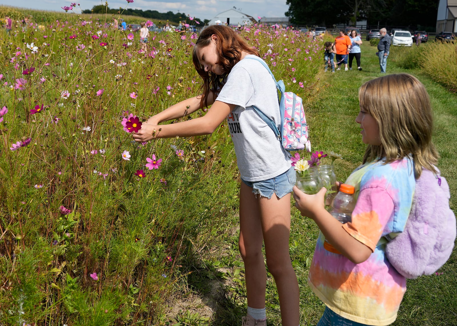 Young members of Temple Beth Or cut flowers  to be symbolically released as part of their Rosh Hashanah ceremony. CONTRIBUTED