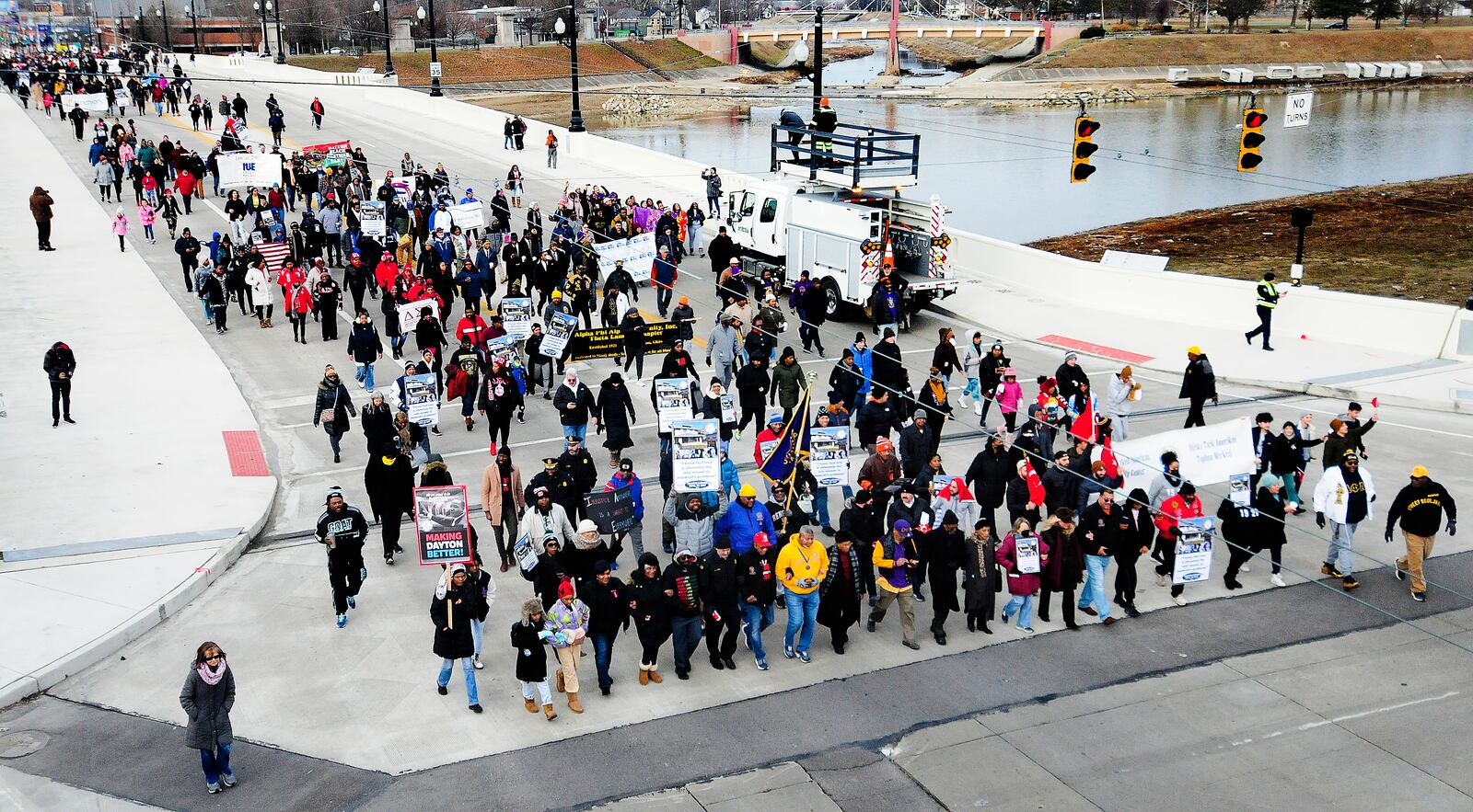 The MLK Memorial March travels over the Third Street bridge into downtown Monday Jan. 16, 2023. MARSHALL GORBY\STAFF