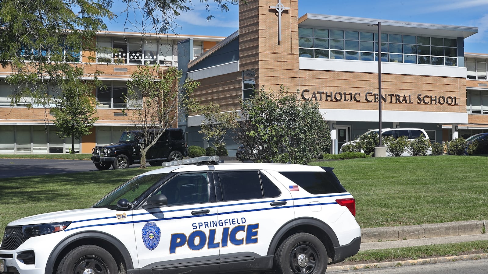 A Springfield police cruiser sits in front of Catholic Central School Friday, Sept. 23, 2022, after a false call reporting an active shooter inside the school on East High Street. BILL LACKEY/STAFF