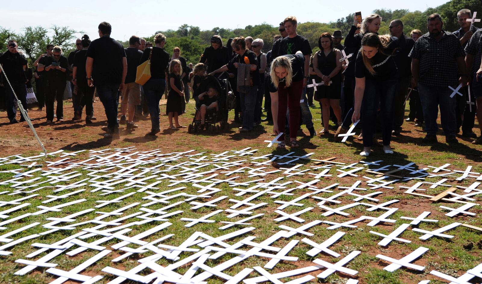 FILE - People place white crosses representing farmers killed in the country at a ceremony at the Vorrtrekker Monument in Pretoria, South Africa, Oct. 30, 2017. (AP Photo, File)