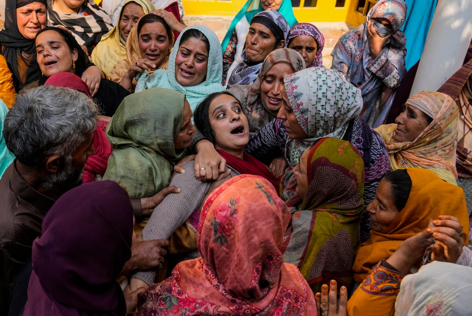 A family member cries of Kashmiri doctor Shahnawaz who was among those killed when gunmen fired at people working on a strategic tunnel project in Indian-controlled Kashmir, at Nadigam village, southwest of Srinagar, Monday, Oct. 21, 2024. (AP Photo/Mukhtar Khan)