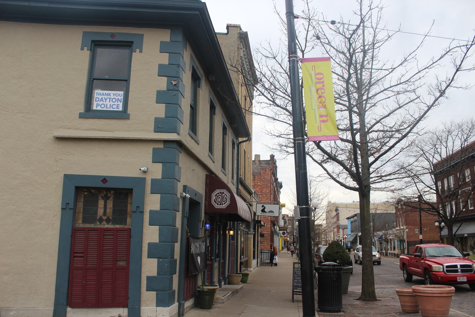 Six months after a 24-year-old Bellbrook man killed nine people in the Oregon District during the worst mass shooting in Ohio history, literal signs of strength, appreciation, resilience and the determination to “do something” about gun violence can be found throughout the historic neighborhood.  A "Dayton Strong" banner and a "Thank you Dayton Police" sign hang at the Trolley Stop Tavern. AMELIA ROBINSON/STAFF