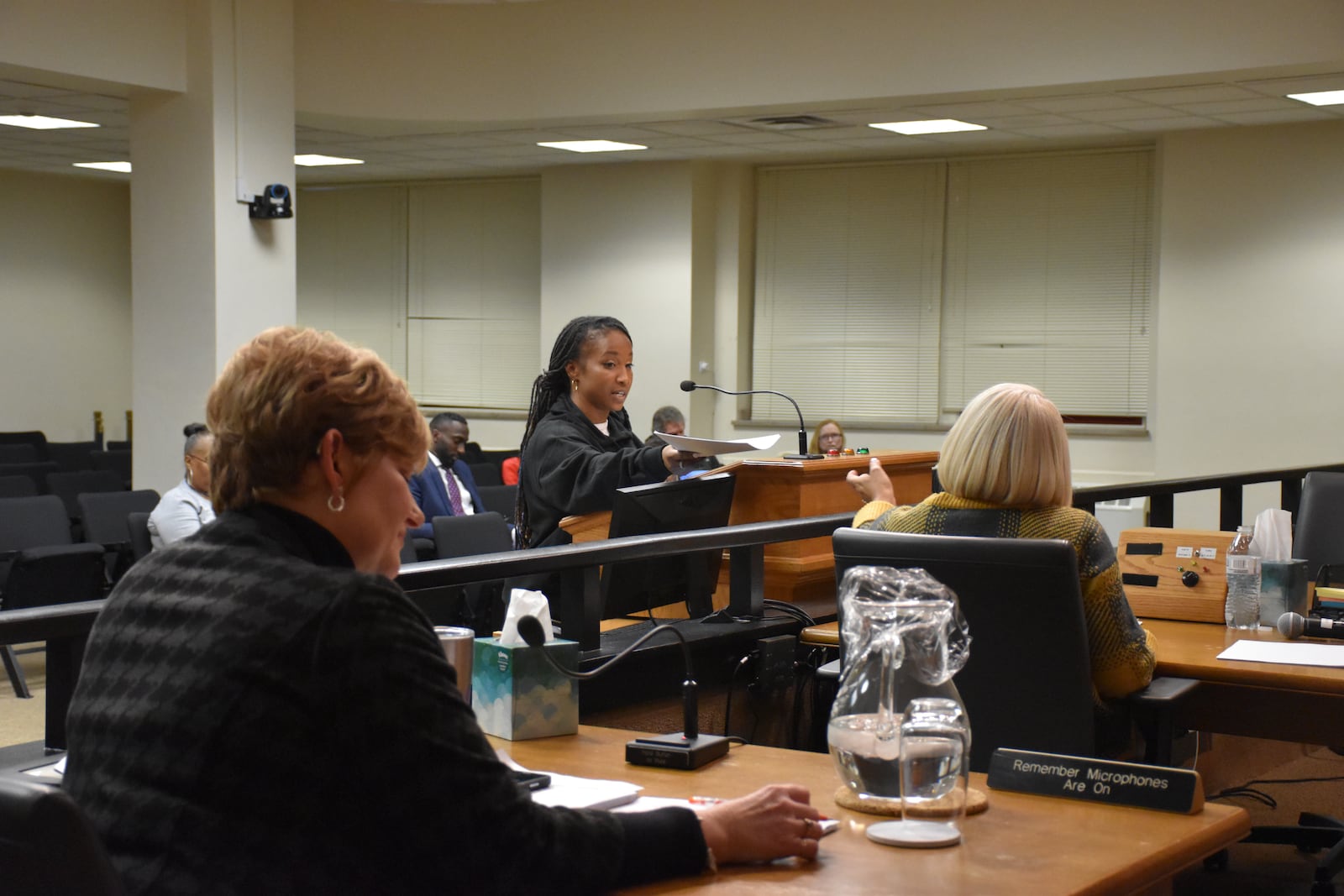 At the Jan. 31, 2024, city commission meeting, Destiny Brown, a community organizer with Advocates for Basic Legal Equality (ABLE), hands Dayton clerk of the commission Regina Blackshear a copy of an email ABLE received from Todd Kinskey, Dayton's director of planning, neighborhoods and development. Brown and other speakers were critical of his comments and City Manager Shelley Dickstein related to a request they made to put a member of the Dayton Tenant Union on a new housing policy steering committee. CORNELIUS FROLIK / STAFF