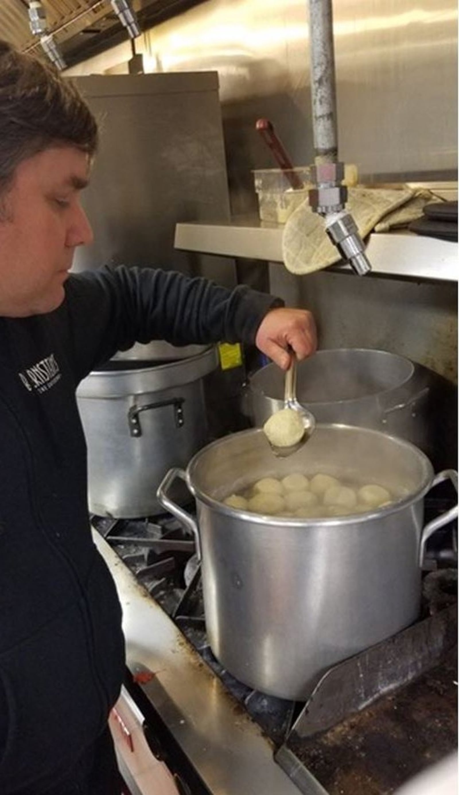 Matzo ball soup is always a popular Seder dish. Adam Baumgarten, owner of Bernstein’s Catering, is at the stove, making Seder meals available to groups and individuals this year. CONTRIBUTED PHOTO