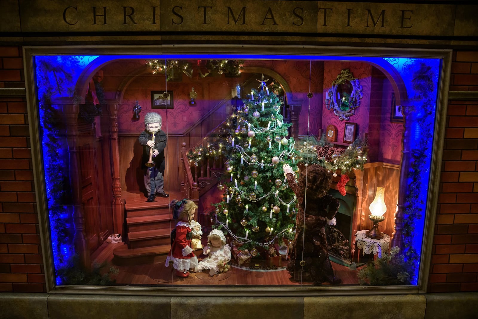 This window, entitled “Christmas Time,” depicts a Victorian Christmas and features photos of the Wright brothers and the Victoria Theatre. CONTRIBUTED/TOM GILLIAM