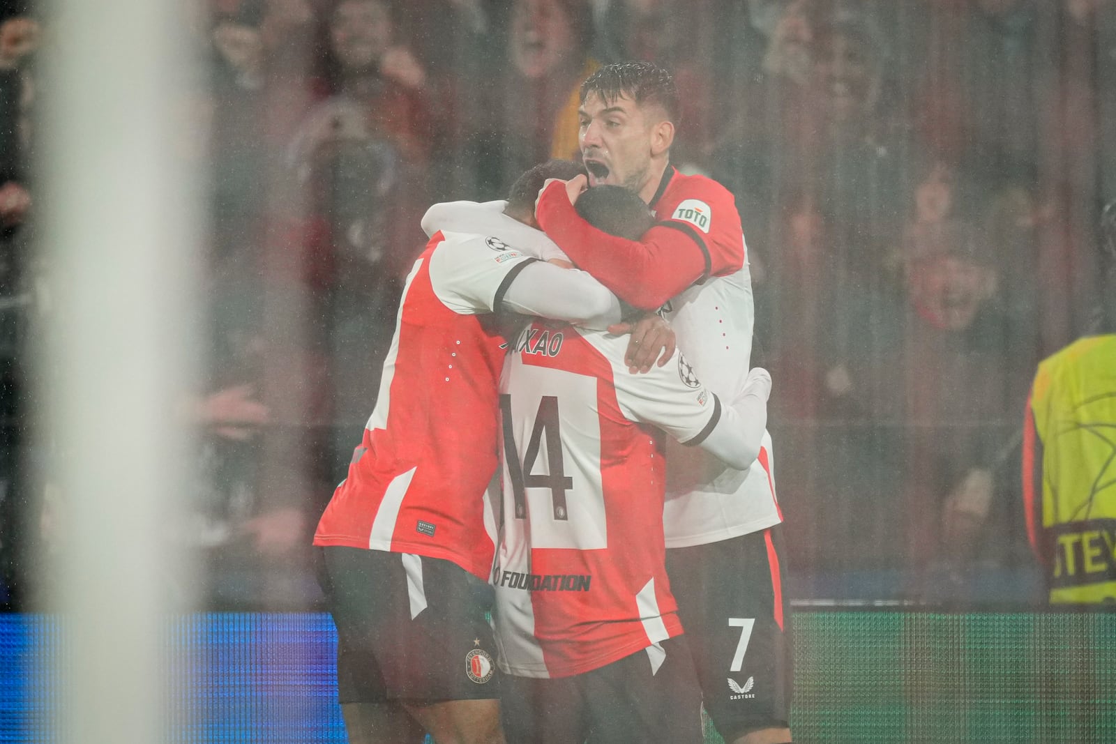 Feyenoord's Igor Paixao, center, celebrates after scoring his side's first goal during the Champions League playoff first leg soccer match between Feyenoord and AC Milan, at the De Kuip stadium, in Rotterdam, Netherlands, Wednesday, Feb. 12, 2025. (AP Photo/Peter Dejong)