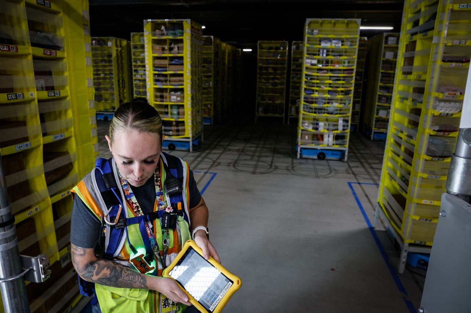 Taylor Woodrum's job title is "quarterback" at the Amazon Union Fulfillment Center. Woodrum oversees robots that move packages around the 2.8 million-square-foot facility. JIM NOELKER/STAFF