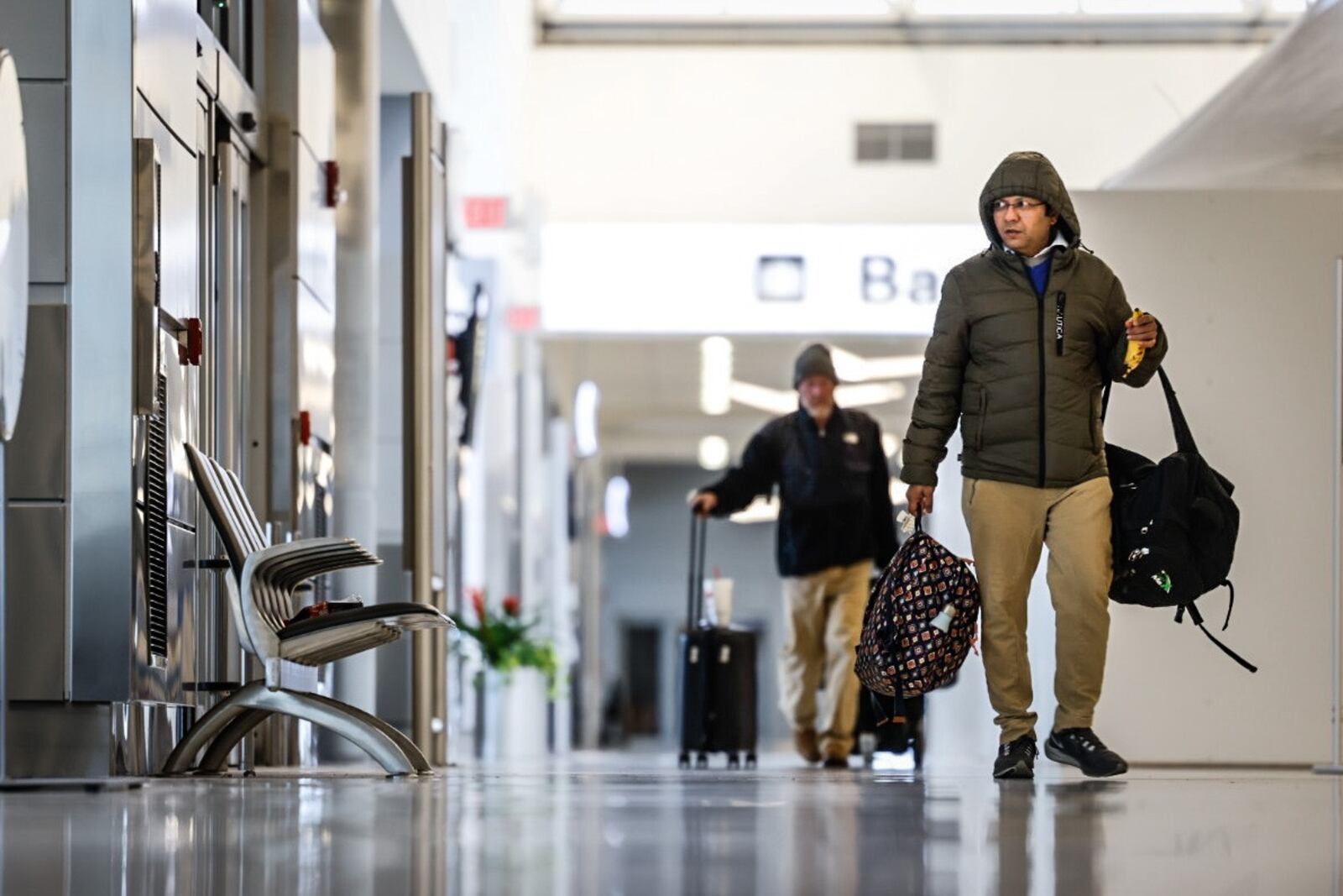 Travelers at the Dayton International Airport walk to the TSA check point Friday November 18, 2022. Jim Noelker/Staff