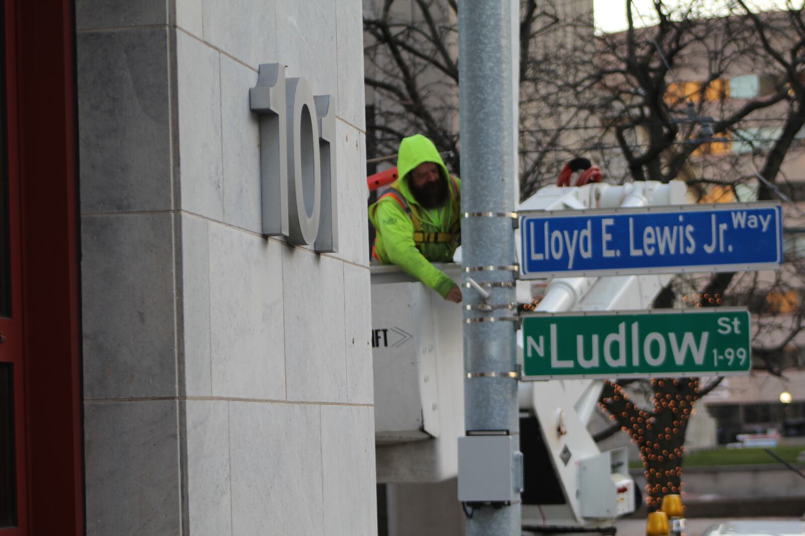 A civil engineering employee works on a light post outside Dayton City Hall. Within the last year, city officials have worried about employee absences due to COVID disrupting city services. CORNELIUS FROLIK / STAFF