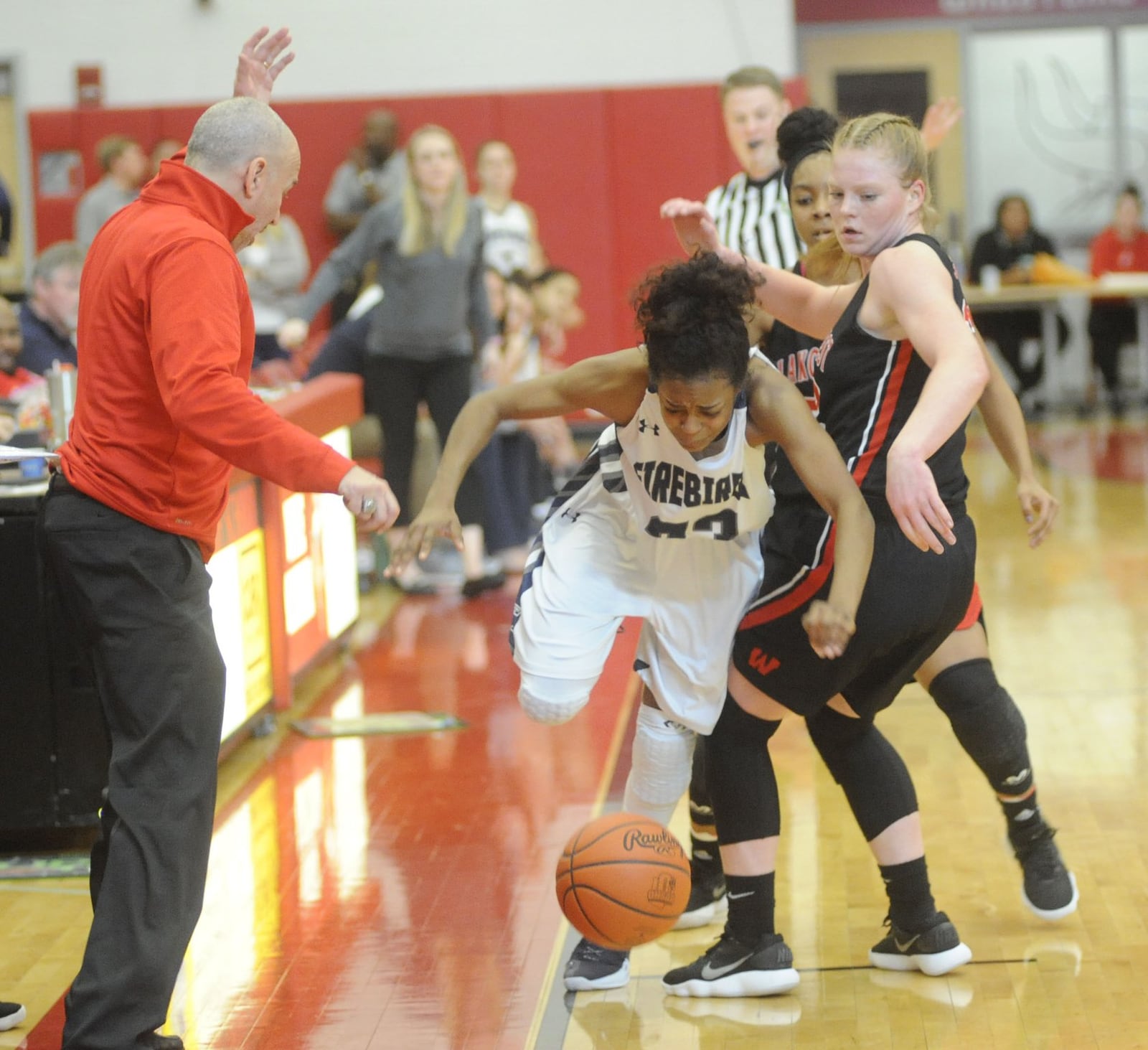 Coach Andy Fishman (left) and Abby Prohaska (right) of Lakota West watch Fairmont s Makira Webster lose control of the ball on the sideline. Lakota West defeated Fairmont 53-29 in a girls high school basketball D-I district final at Princeton on Sat., March 3, 2018. MARC PENDLETON / STAFF