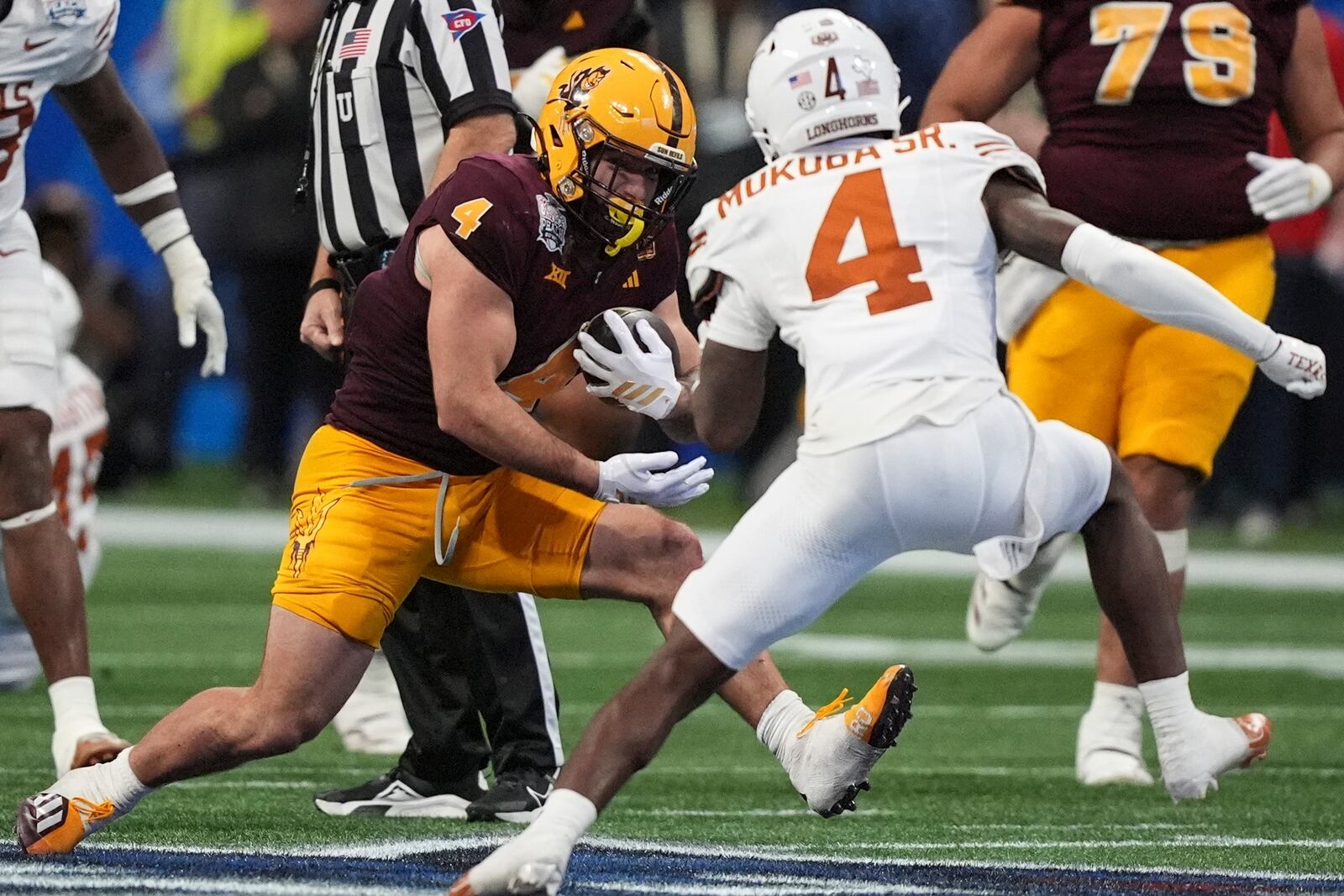 Arizona State running back Cam Skattebo (4) runs into Texas defensive back Andrew Mukuba (4) during the second half in the quarterfinals of a College Football Playoff game, Wednesday, Jan. 1, 2025, in Atlanta. (AP Photo/Brynn Anderson)