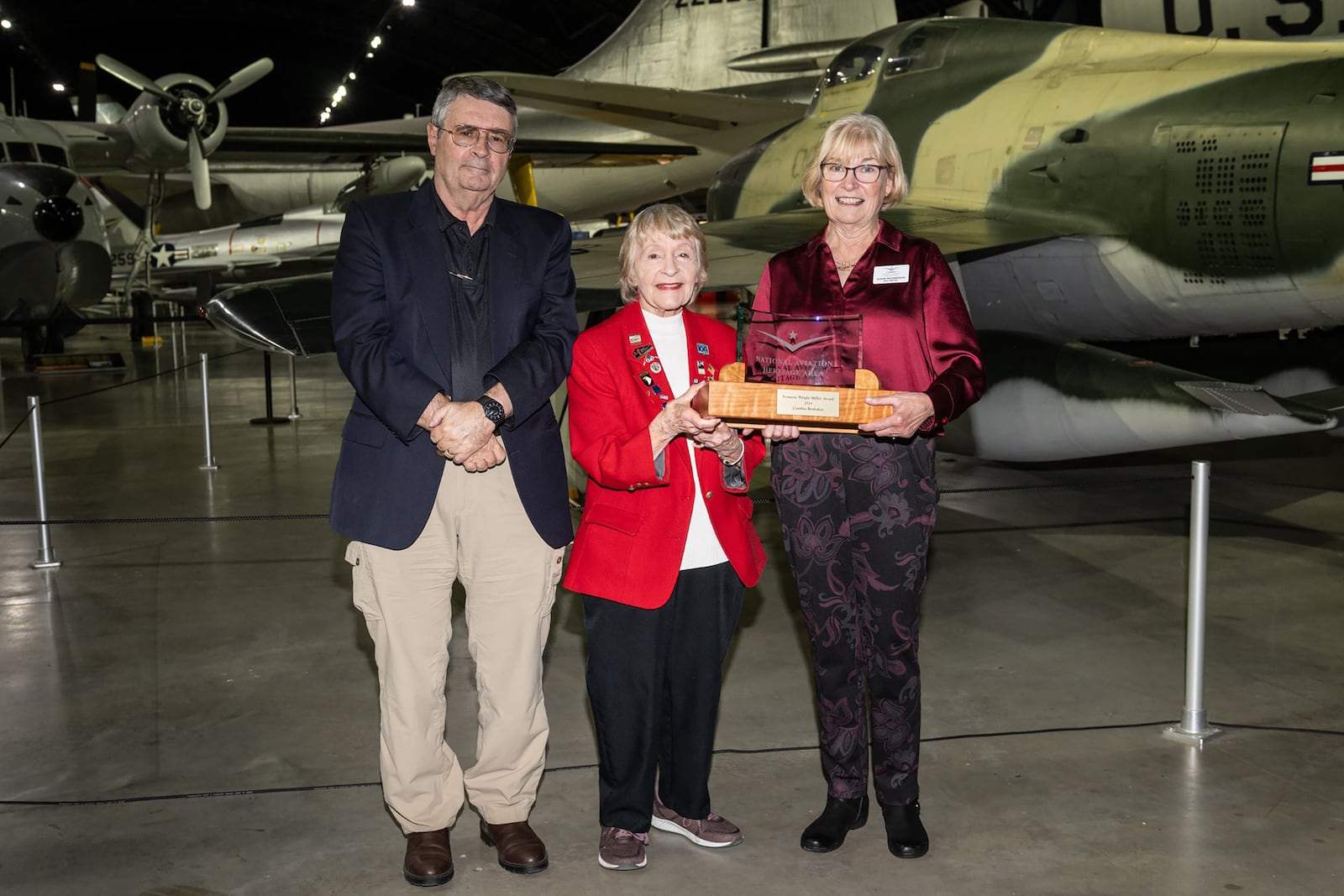 Cynthia Brubaker (center) receiving the Ivonette Wright Miller Award at the National Museum of the US Air Force on November 12. (L-R) Museum director David Tillotson, Brubaker, Susan Richardson of the Dayton Aviation Foundation.


