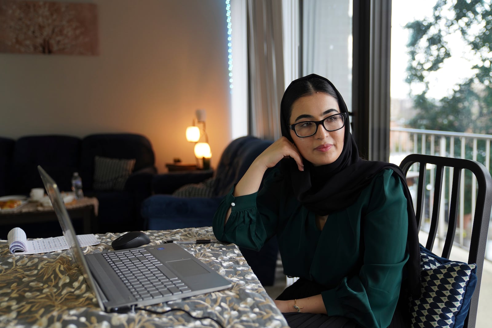 Marjila Badakhsh, an Afghan refugee who came to the United States in 2021 after American troops left Afghanistan, sits at her computer in Alexandria, Va., Wednesday, March 5, 2025. She was recently laid off from her position with the Lutheran Social Services National Capital Area resettlement program when the Trump administration upended the federal refugee program. (AP Photo/Jessie Wardarski)