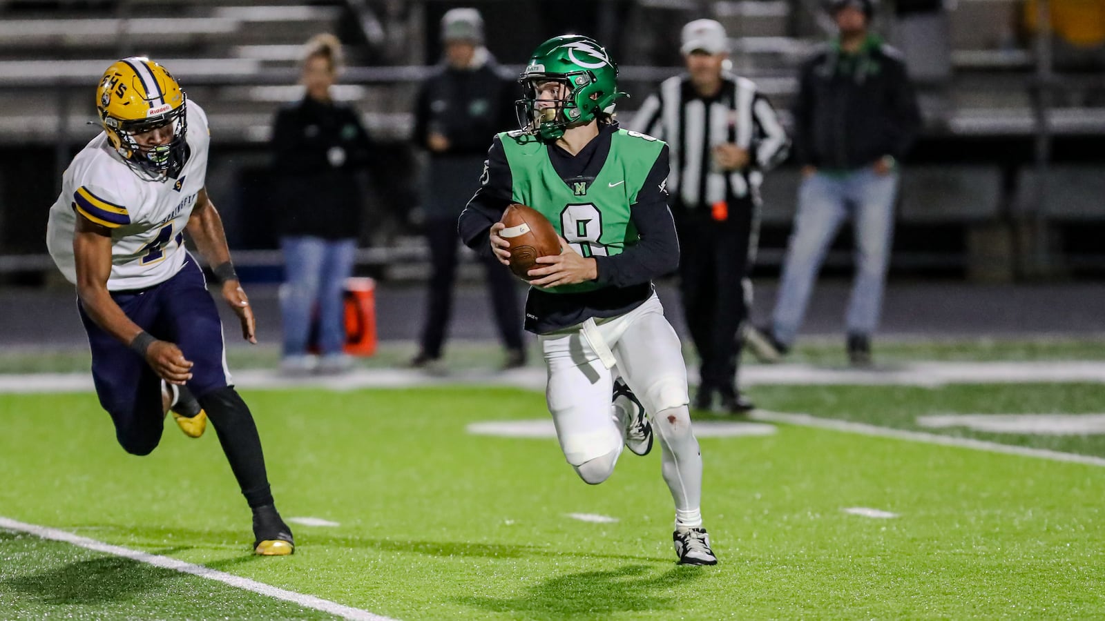 Northmont High School junior quarterback Brady Lupton is chased by Springfield sophomore Ty Thompson during their game 
 on Thursday night at Premier Health Stadium. Springfield won 48-7. Michael Cooper/CONTRIBUTED