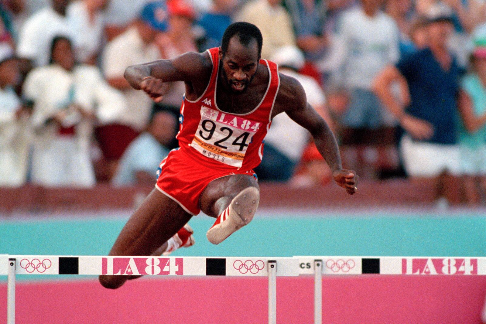 FILE - United States' Edwin Moses jumps a hurdle on his way to winning the gold medal in the 400-meter hurdles at the Summer Olympic Games in Los Angeles, Aug. 5, 1984. (AP Photo/File)