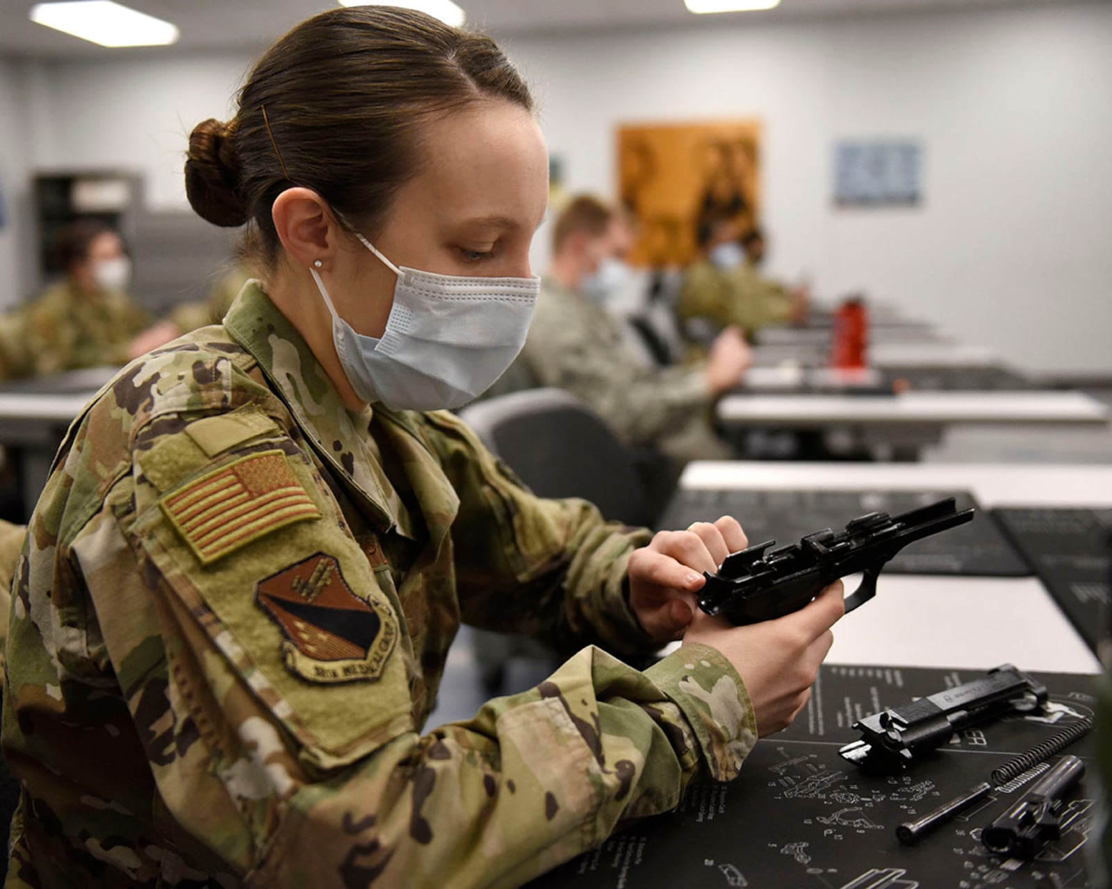 2nd Lt. Mariah Armstrong, an 88th Medical Group critical care nurse, practices disassembling the M9 pistol during a qualification course at Wright-Patterson Air Force Base on Feb. 18. U.S. AIR FORCE PHOTO/TY GREENLEES