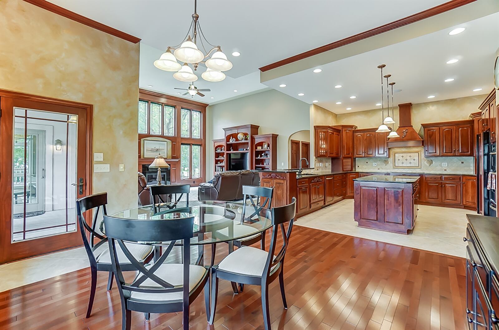 Cherry cabinets in the kitchen provide plenty of storage and include pull-out shelves, 2 lazy Susans and 2 appliance garages. The appliances have matching wood panel coverings and a cherry hood vent is above the cooktop that has an ornate ceramic-tile backsplash. A large island has additional storage, an extended counter for breakfast bar seating. CONTRIBUTED PHOTO