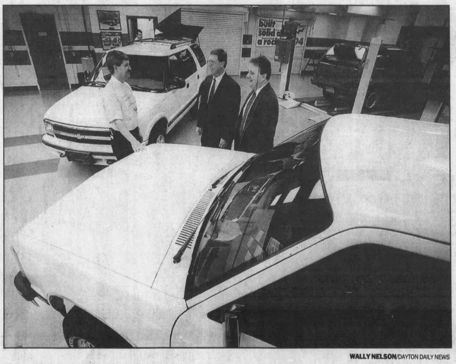 Bob Roth, left, manager of GM's Moraine Assembly Plant, and Roger Tehan, center, and Dave Guyselman of Urbana Motors Inc. discuss the 1994 sport utility vehicle. WALLY NELSON / STAFF