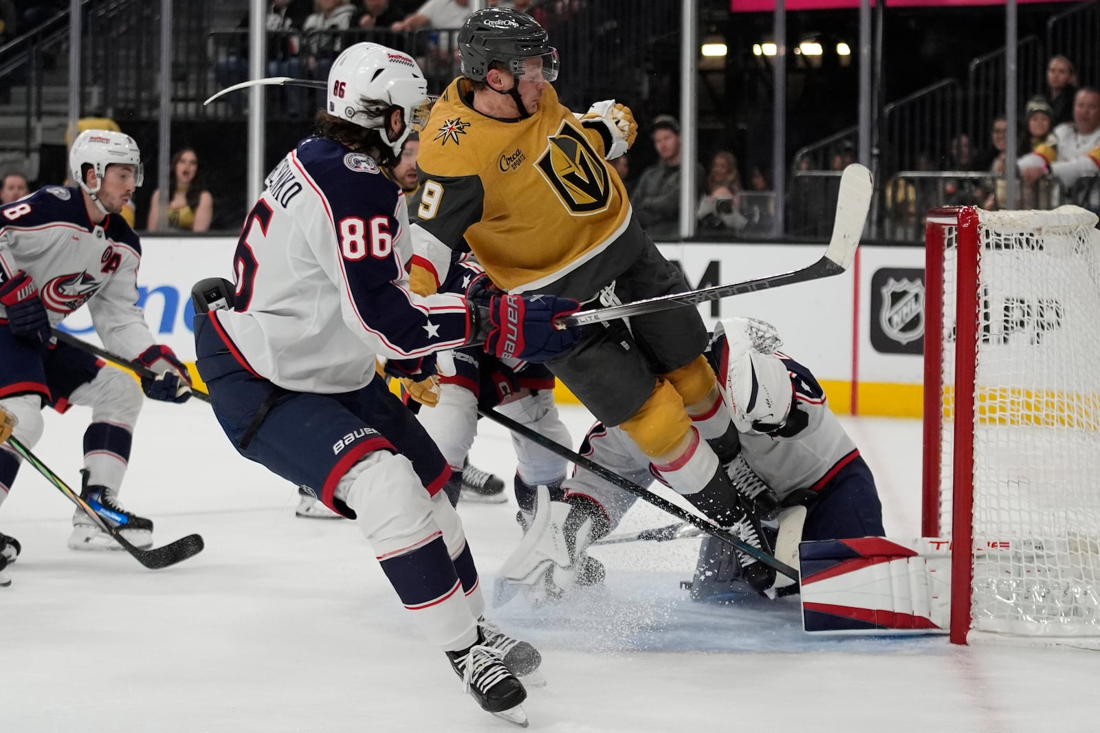 Vegas Golden Knights center Jack Eichel (9) collides with Columbus Blue Jackets goaltender Elvis Merzlikins (90) during the second period of an NHL hockey game Thursday, Jan. 30, 2025, in Las Vegas. (AP Photo/John Locher)