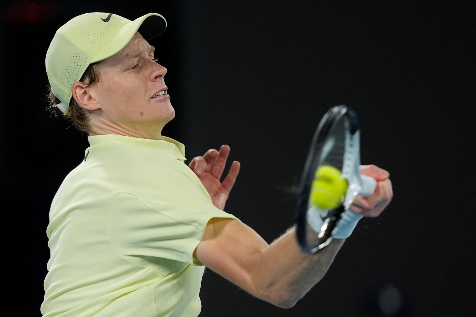 Jannik Sinner of Italy plays a forehand return to Ben Shelton of the U.S. during their semifinal match at the Australian Open tennis championship in Melbourne, Australia, Friday, Jan. 24, 2025. (AP Photo/Asanka Brendon Ratnayake)