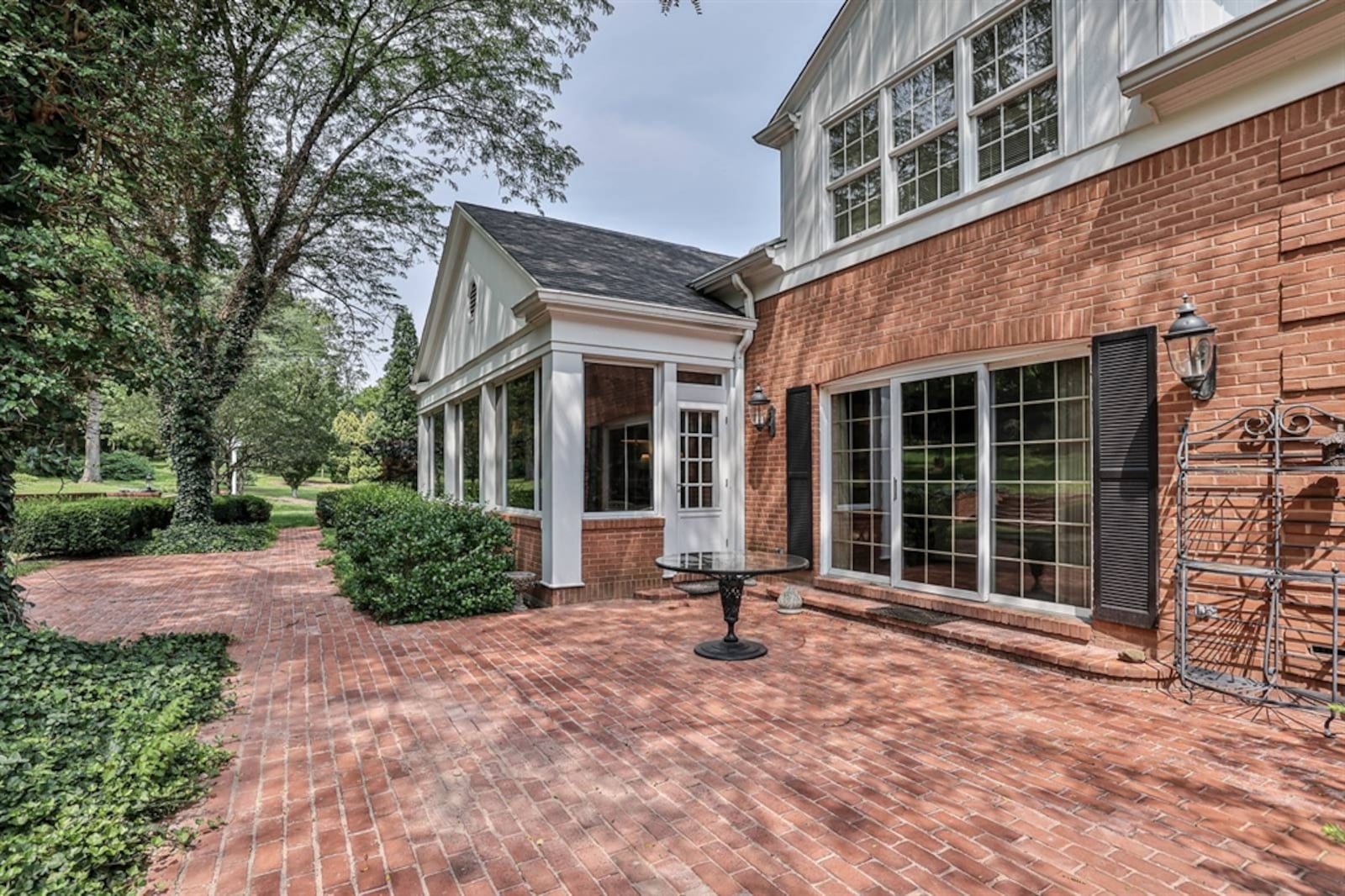 A large patio extends across the back and has views of the terraced garden and arboretum. Contributed