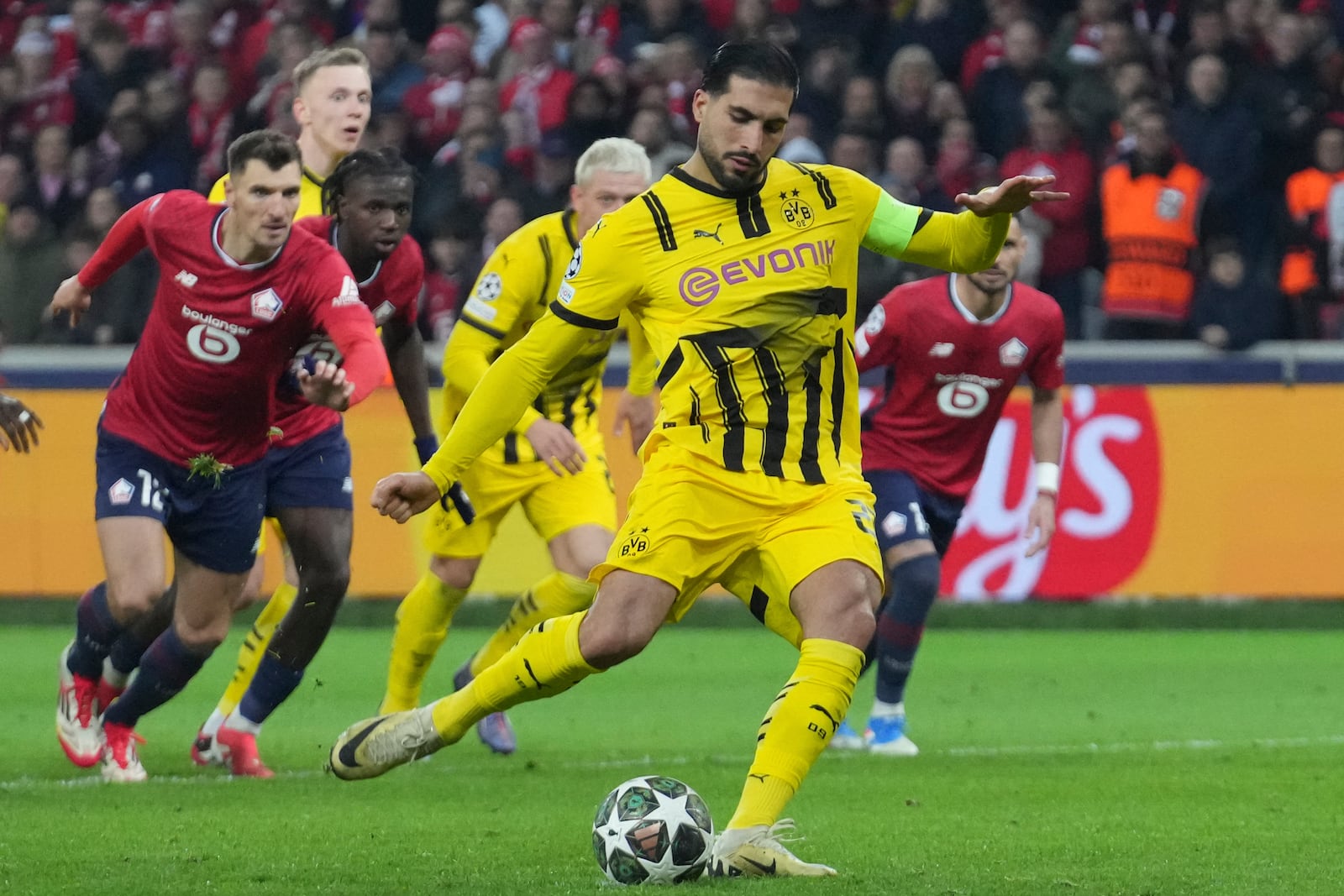 Dortmund's Emre Can scores from a penalty kick during the Champions League round of 16 second leg soccer match between Lille and Borussia Dortmund in Villeneuve-d'Ascq , Wednesday, March 12, 2025. (AP Photo/Michel Euler)