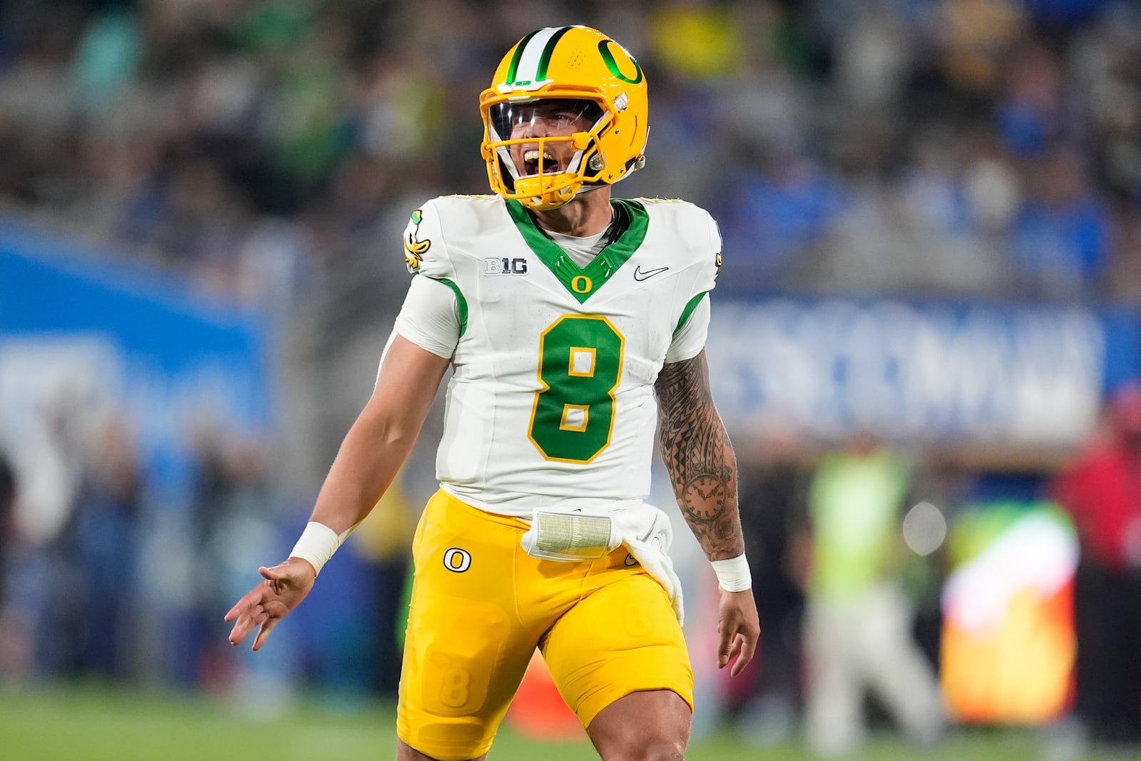 Oregon quarterback Dillon Gabriel celebrates after throwing a touchdown pass to wide receiver Tez Johnson during the first half of an NCAA college football game against UCLA, Saturday, Sept. 28, 2024, in Pasadena, Calif. (AP Photo/Marcio Jose Sanchez)