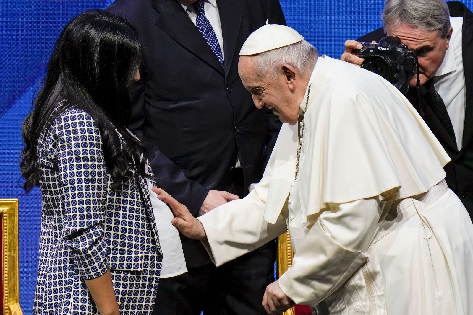 FILE - Pope Francis greets a pregnant woman at the end of a conference to discuss the "demographic winter" and "empty cribs" problem Italy is facing, at Auditorium della Conciliazione, in Rome, May 12, 2023. (AP Photo/Alessandra Tarantino, File)