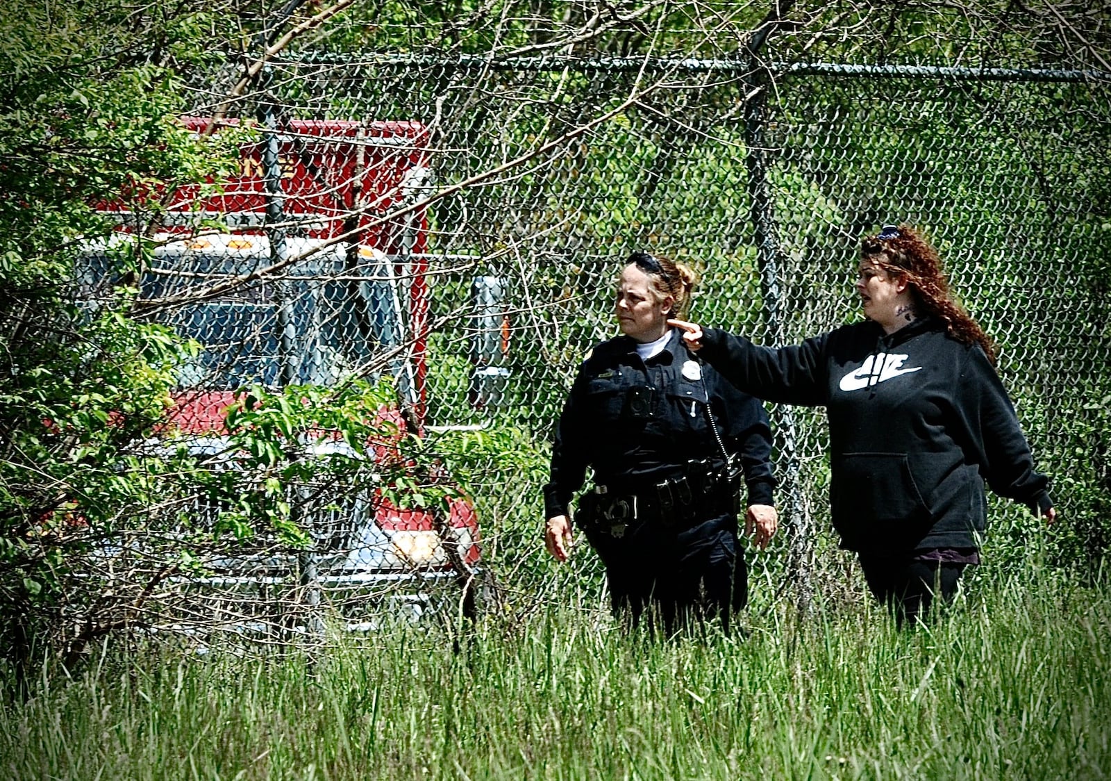 Amanda Rosales, the mother of missing 7-year-old Lucas Rosales, searched Eastwood MetroPark with a Dayton police officer and other crews Thursday, May 4, 2023. MARSHALL GORBY/STAFF