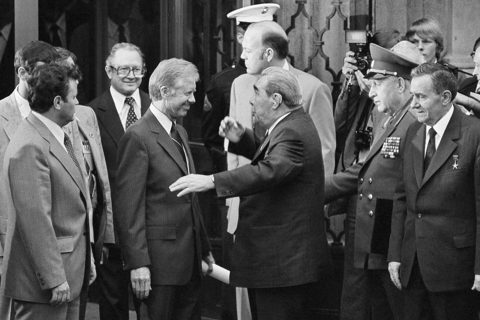 FILE - President Jimmy Carter, left center, smiles as Soviet President and Party Chief Leonid Brezhnev, center, jokes around him outside the U.S. Embassy in Vienna, Austria, June 16, 1979, before they head for their second round of talks prior to the signing of the SALT II Treaty. (AP Photo, File)