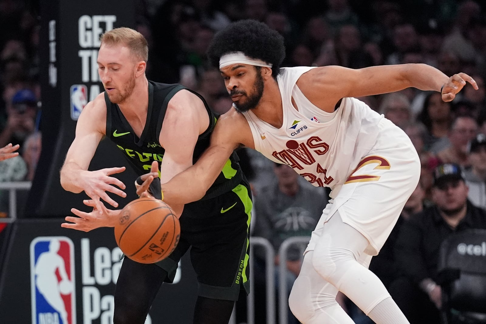 Cleveland Cavaliers center Jarrett Allen, right, steals the ball from Boston Celtics forward Sam Hauser, left, during the first half of an NBA basketball game, Friday, Feb. 28, 2025, in Boston. (AP Photo/Charles Krupa)