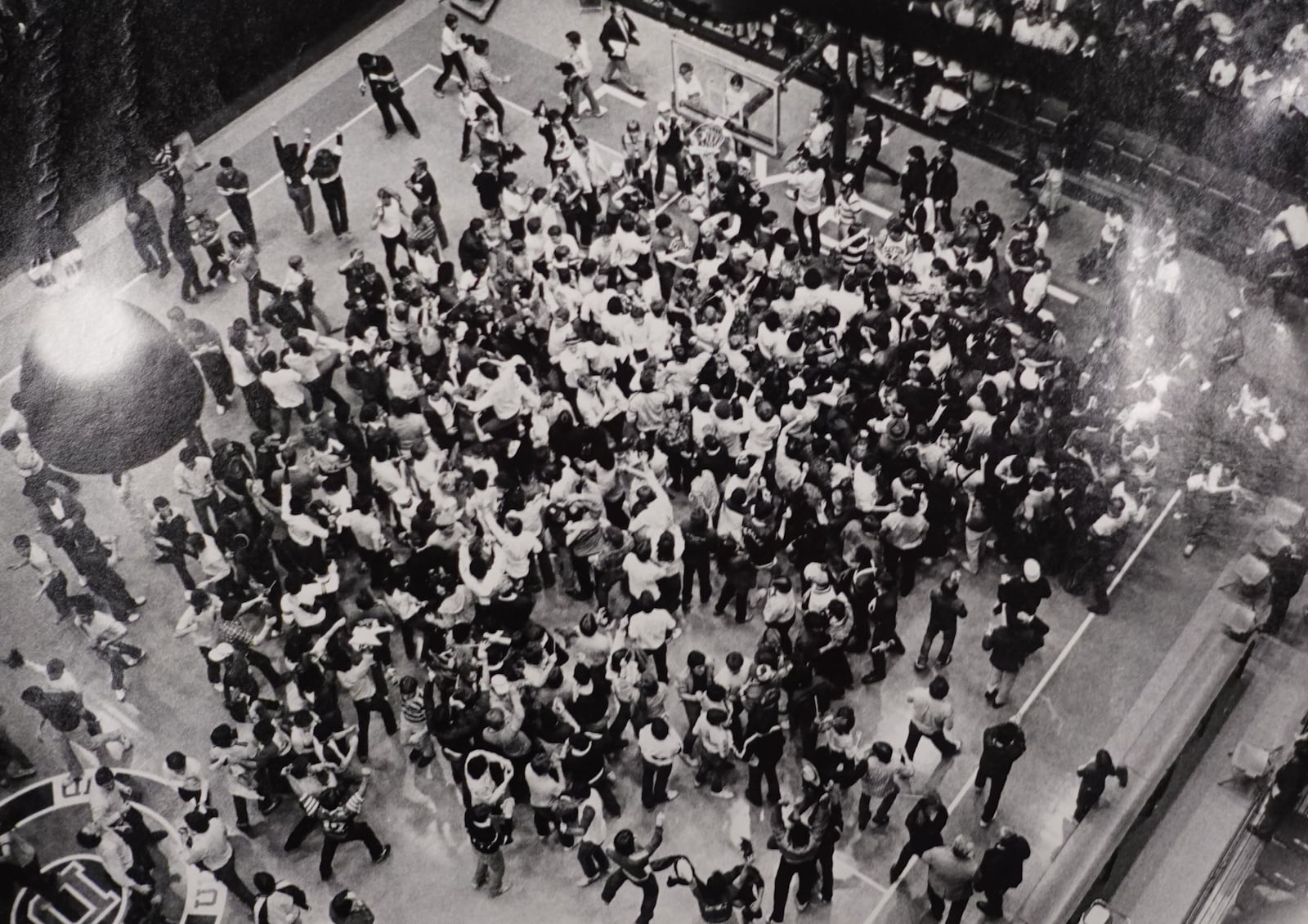 Dayton Flyers basketball. Fans on the court after an upset win over DePaul, 72-71, on a nationally televised game. COURTESY OF WRIGHT STATE UNIVERSITY, DAYTON DAILY NEWS ARCHIVE