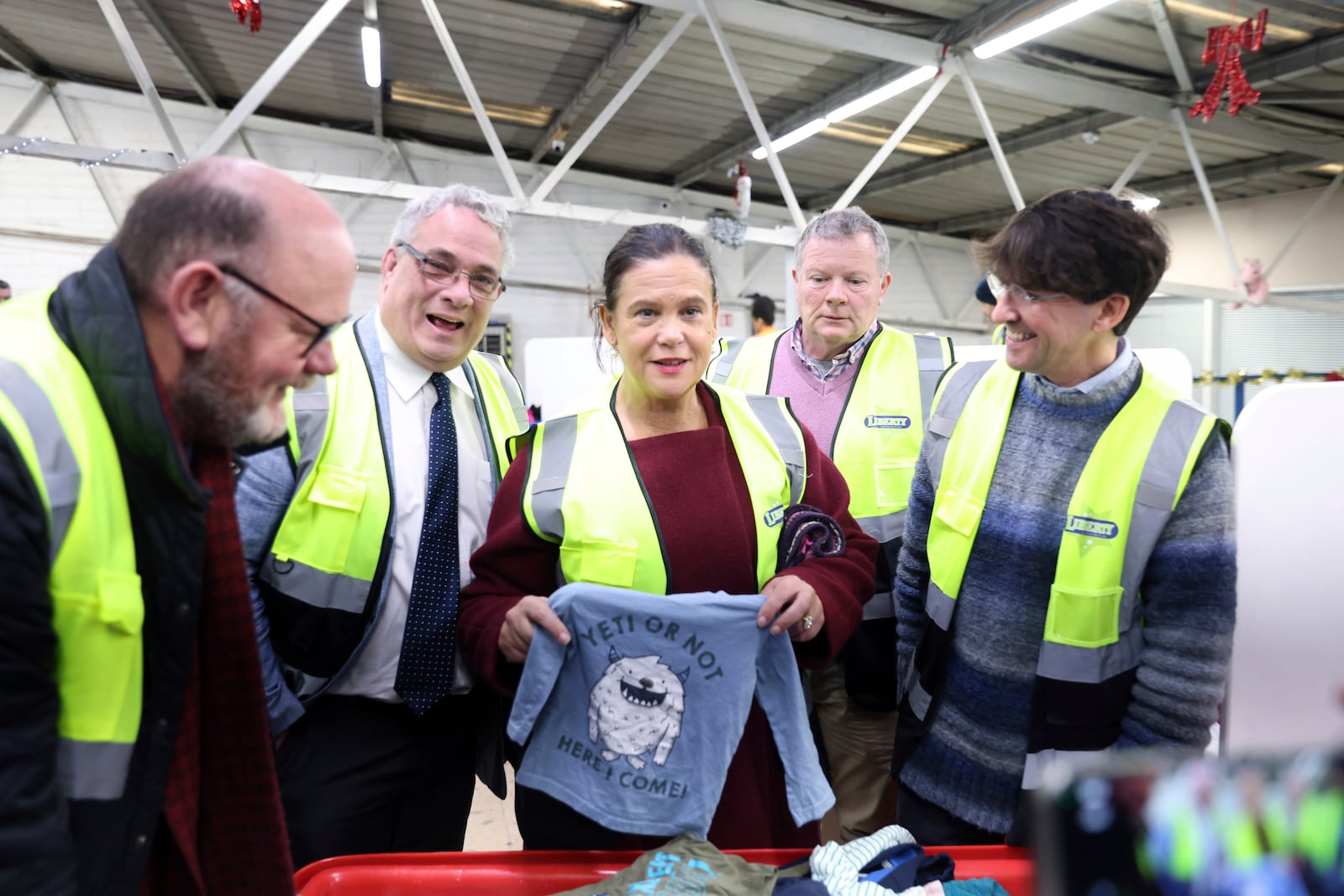 Sinn Fein leader Mary Lou McDonald, center, visits Liberty Recycling in Dublin, Ireland, Tuesday, Nov. 26, 2024, ahead of Ireland's election on Friday. (AP Photo/Peter Morrison)