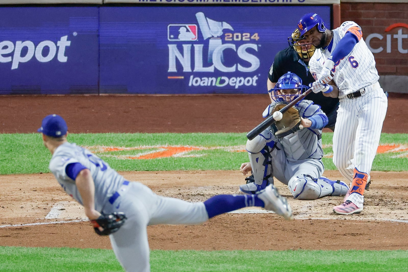 New York Mets' Starling Marte hits a two-run double against the Los Angeles Dodgers during the third inning in Game 5 of a baseball NL Championship Series, Friday, Oct. 18, 2024, in New York. (AP Photo/Adam Hunger)