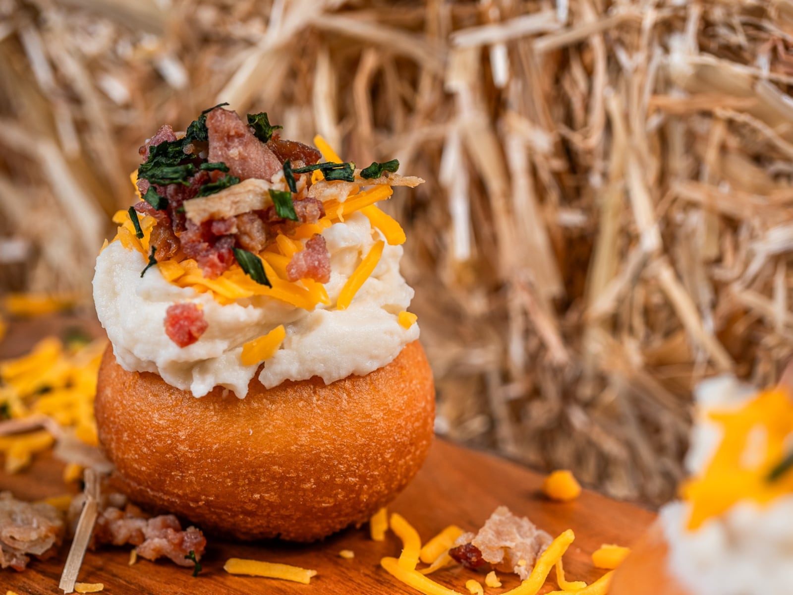 Death Grip Donuts has introduced the Mash Tater, a donut topped with a mound of mashed potatoes, melted cheddar cheese, crispy bacon and a sprinkle of chives (CONTRIBUTED PHOTO).