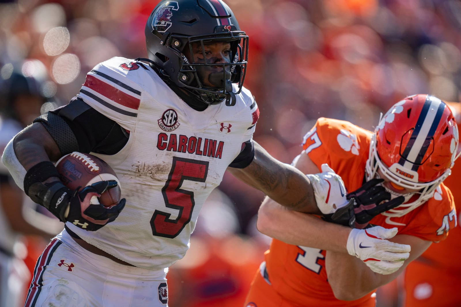 South Carolina running back Raheim Sanders (5) tries to break a tackle from Clemson linebacker Sammy Brown (47) in the first half of an NCAA college football game Saturday, Nov. 30, 2024, in Clemson, S.C. (AP Photo/Jacob Kupferman)