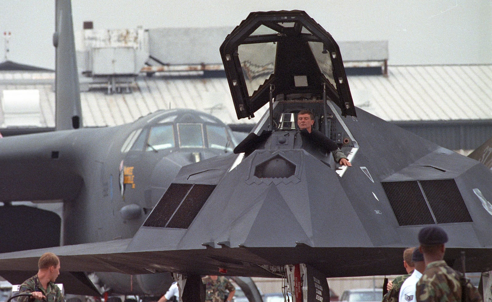 F-117A Stealth Fighter is towed into position in front of a B-52 Stratofortress as part of the Desert Storm display in 1990