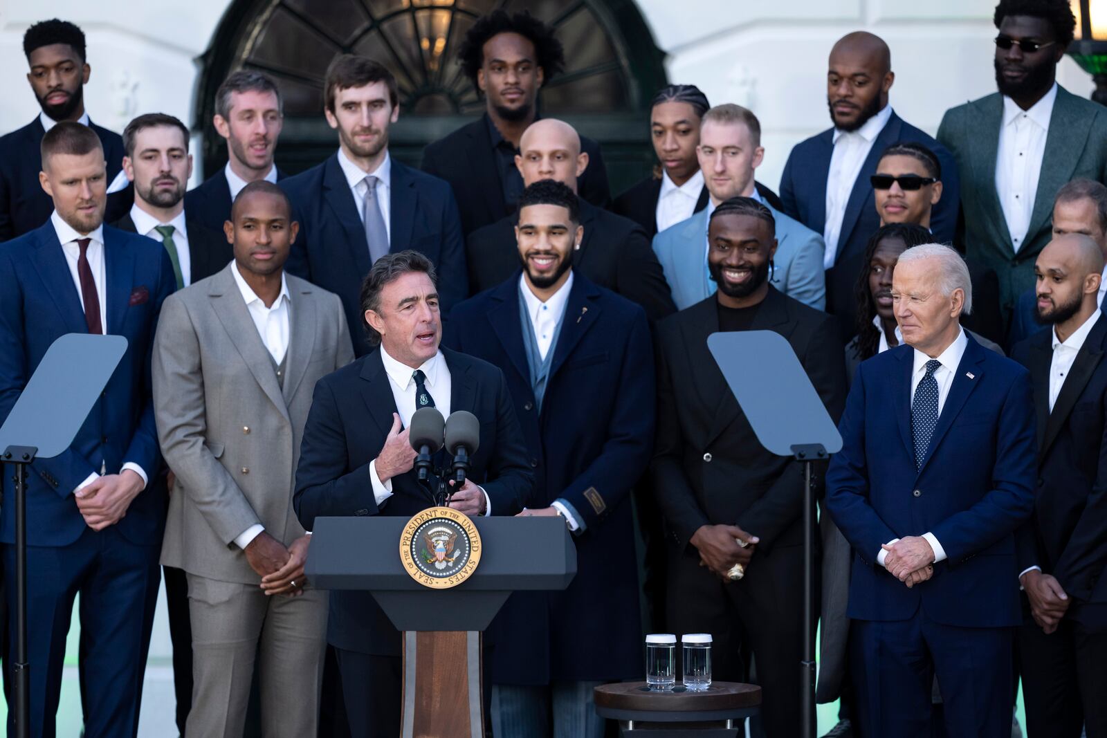 President Joe Biden, right, listens as Boston Celtics owner Wyc Grousbeck speaks at an event welcoming the Boston Celtics to celebrate their victory in the 2024 National Basketball Association Championship, on the South Lawn of the White House in Washington, Thursday, Nov. 21, 2024. (AP Photo/Ben Curtis)