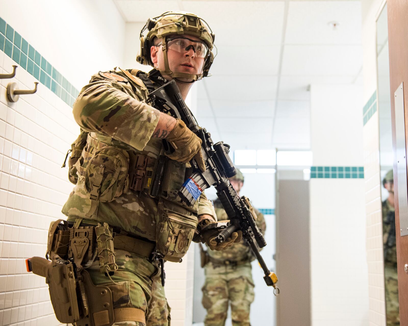 An 88th Security Forces Squadron Defender covers his partner while clearing a room during an active-shooter exercise Aug. 10 at Wright-Patterson Air Force Base. The exercise was conducted to test the skills of first responders in a potential real-world scenario. U.S. AIR FORCE PHOTO/JAIMA FOGG