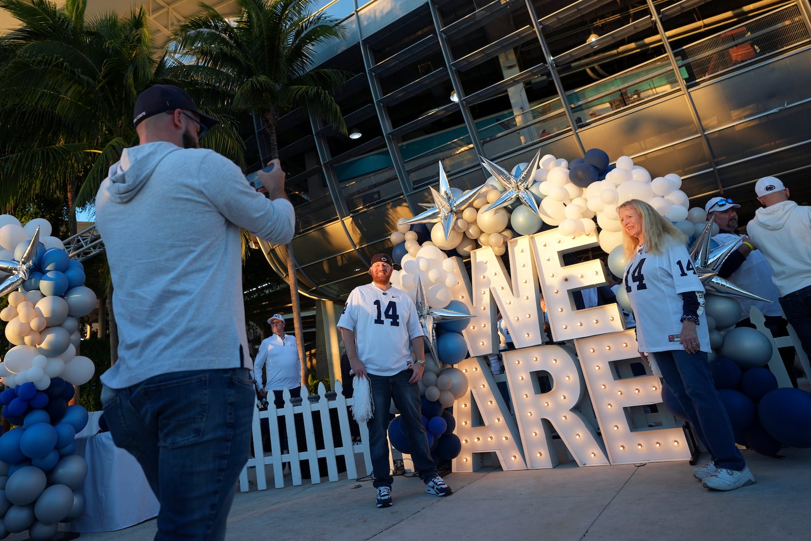 FILE - Notre Dame fans pose for photos before the Orange Bowl College Football Playoff semifinal game between Notre Dame and Penn State, Thursday, Jan. 9, 2025, in Miami Gardens, Fla. (AP Photo/Rebecca Blackwell, File)