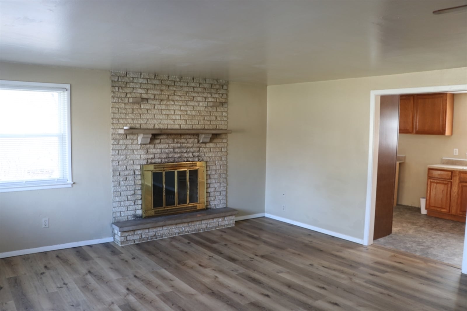 The formal entry opens directly into the living room, which has wood-plank flooring and a fireplace. CONTRIBUTED BY KATHY TYLER