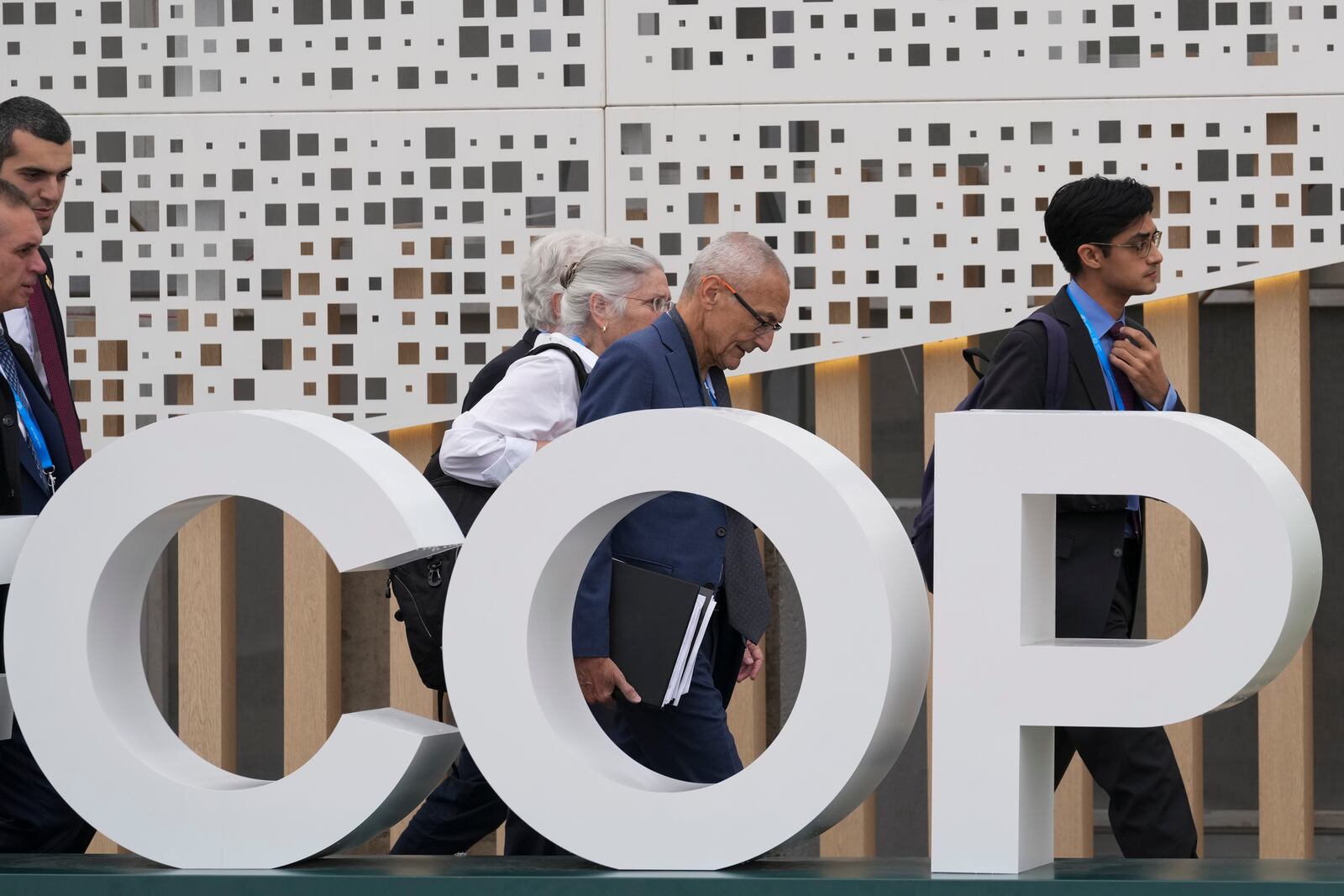 John Podesta, U.S. climate envoy, center right, and U.S. Deputy Climate Envoy Sue Biniaz, center, walk outside the venue for the COP29 U.N. Climate Summit, Saturday, Nov. 23, 2024, in Baku, Azerbaijan. (AP Photo/Sergei Grits)