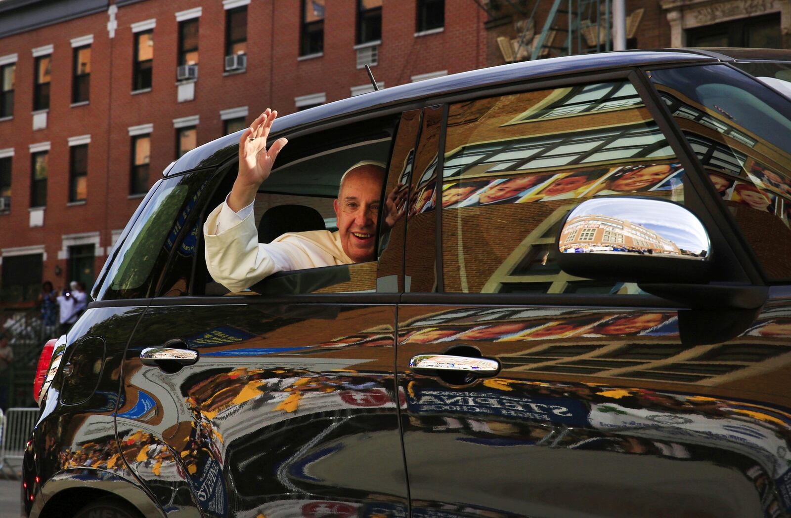 FILE - In this Sept. 25, 2015 file photo, Pope Francis arrives in his car for a visit to Our Lady Queen of Angels School in the Harlem neighborhood of New York. (Eric Thayer/Pool Photo via AP, files)